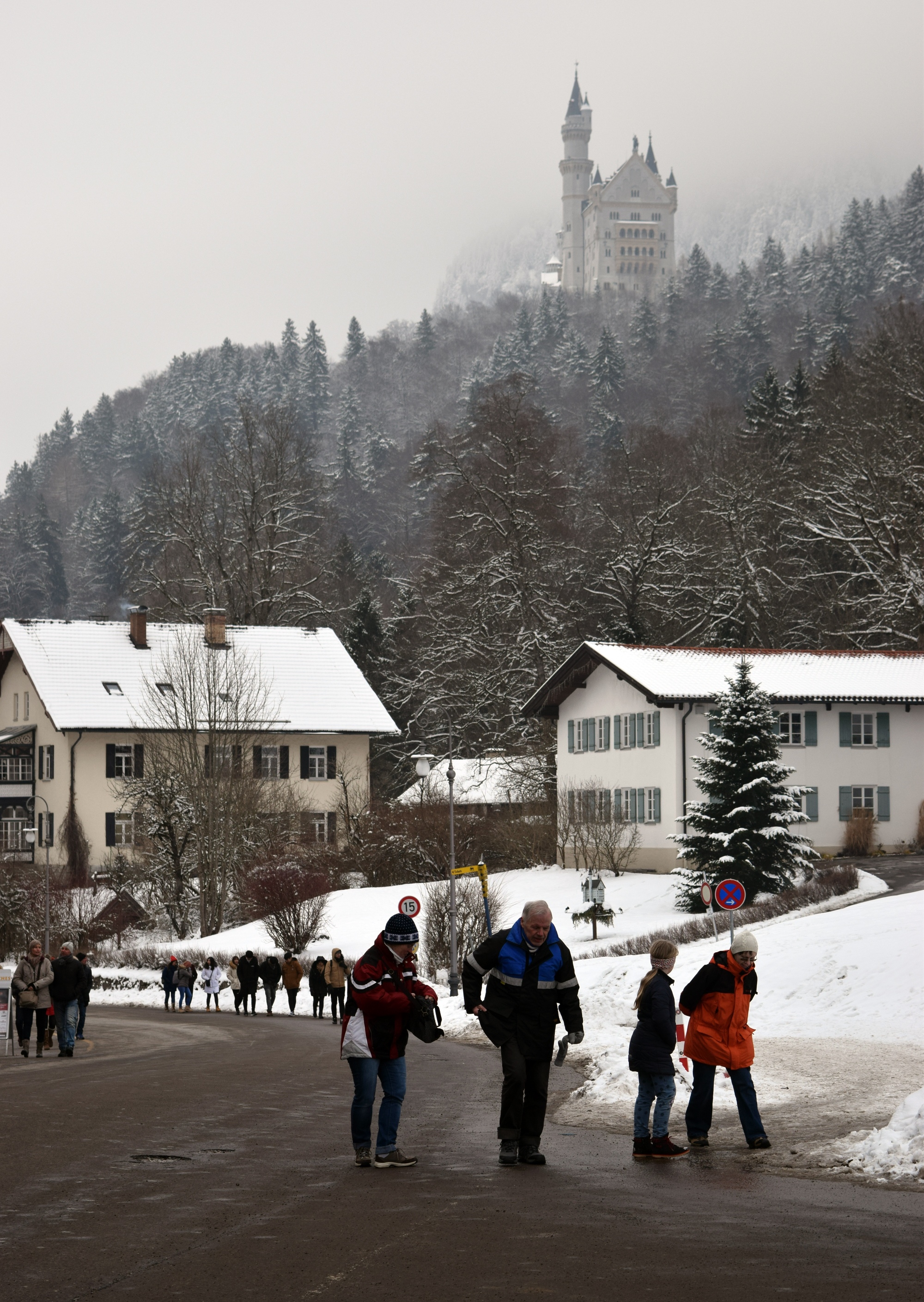 An attempt at getting the best photo of Neuschwanstein Castle, with tourists on a road in the foreground.